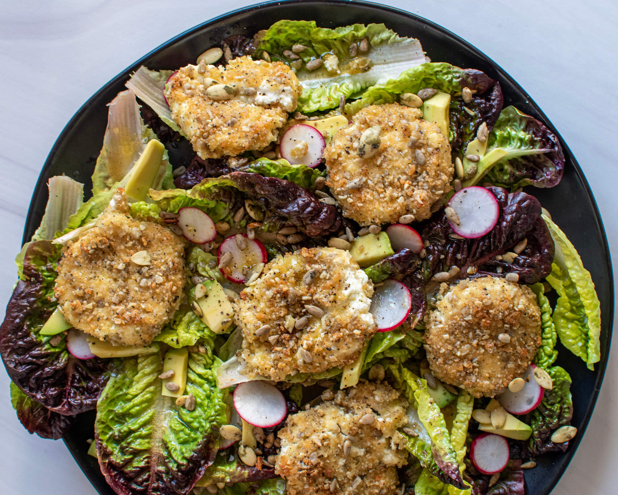 Warm Seed-Breaded Goat Cheese Medallions on Salad