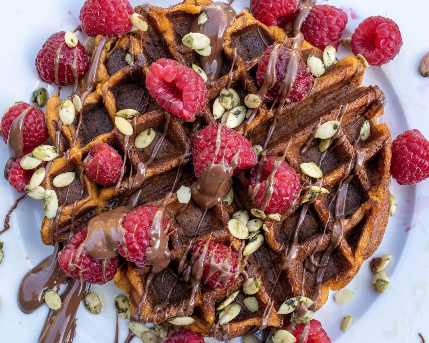 Sweet Potato Waffles topped with raspberries and Nutella